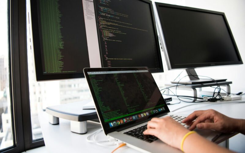 shallow focus photo of person using MacBook